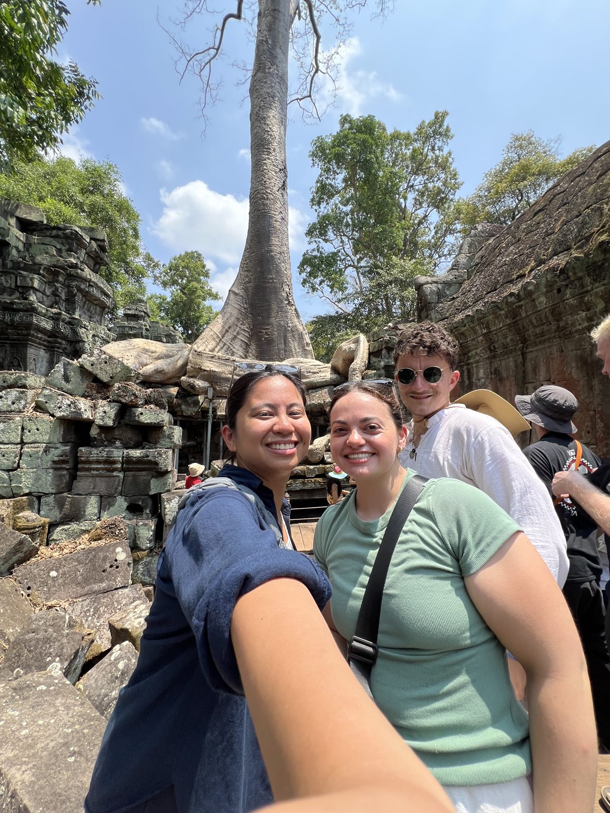 Ollie and friends among the roots and stone ruins at Ta Prohm