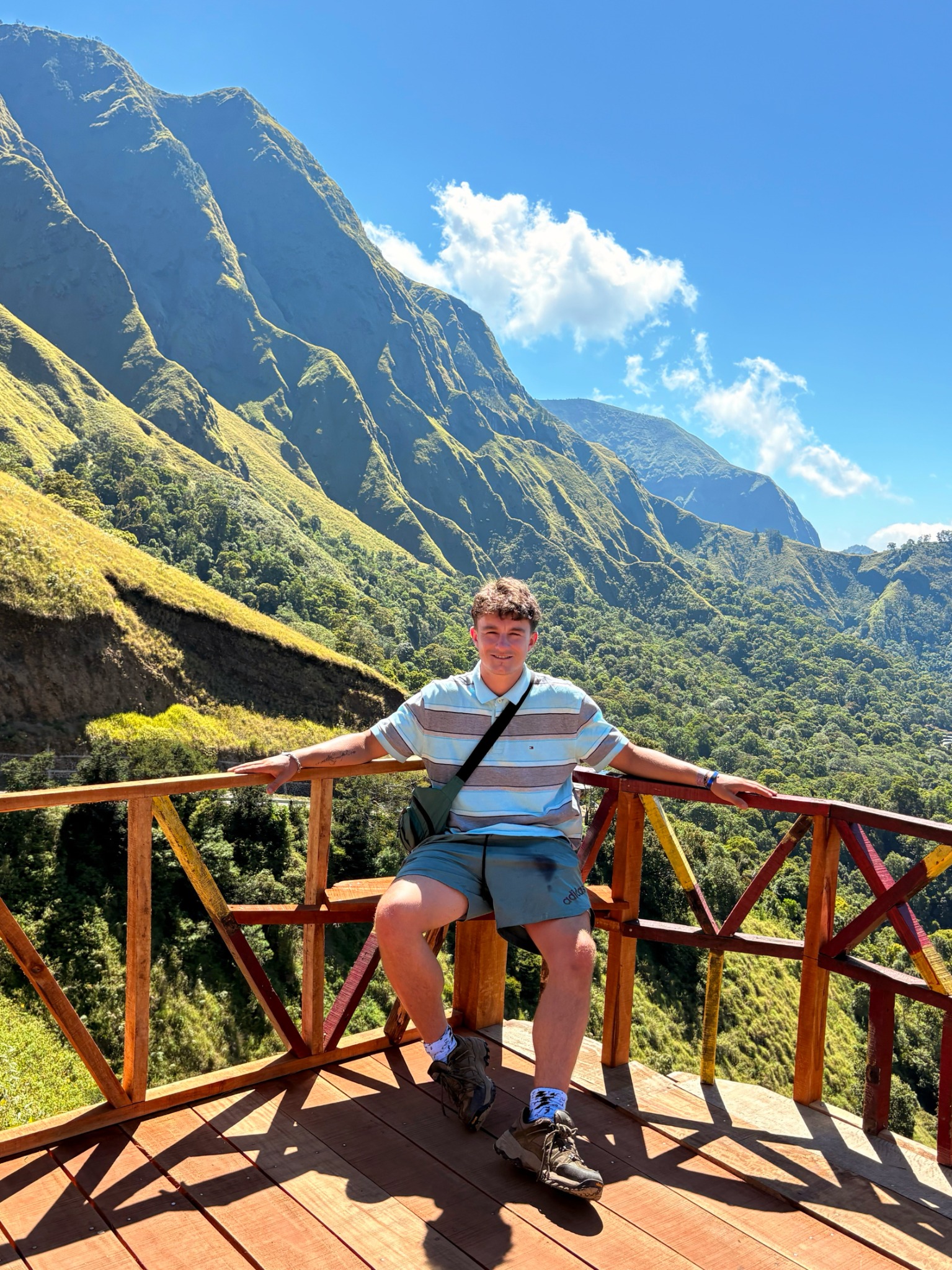 Ollie smiling at a mountain viewpoint in Southeast Asia